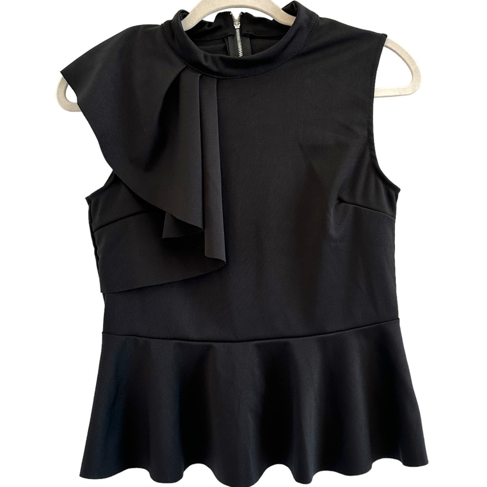 Sleeveless statement shoulder peplum